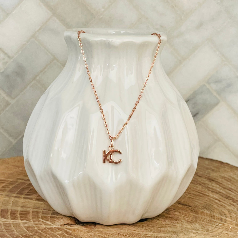 
                  
                    Show your love for your hometown with this KC Necklace. A simple and elegant design, this necklace is perfect for everyday wear. The rose gold finish is beautiful and timeless. Whether you're dressing up for a night out or just running errands, this necklace is a great way to show your KC pride.  KC Rhinestone Necklace 18K gold plated 18 inch necklace with 3 inch extender
                  
                