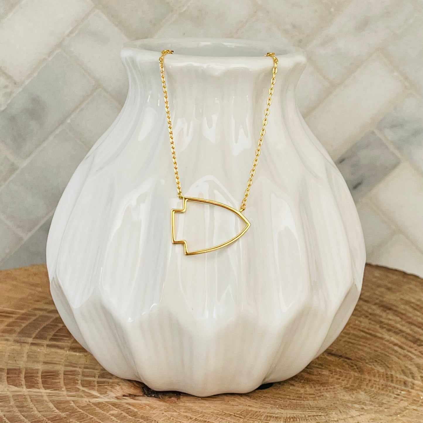 No matter where you go, you can show off your support for your favorite Kansas City team with this gold arrowhead necklace. Made of high-quality gold, this necklace is a must-have for any fan. Whether you're dressing up for a game or just accenting your everyday style, this necklace is a great way to show your KC love.  KC Arrowhead Necklace 18K gold plated 18 inch necklace with 3 inch extender