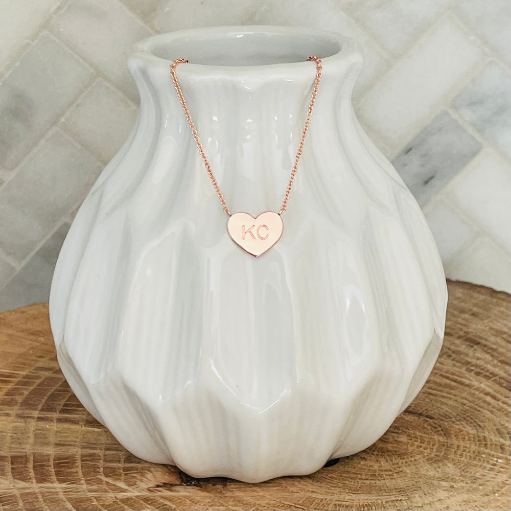 
                  
                    A little piece of Kansas City love. This KC necklace is the perfect way to show your love for your home town. With its simple and elegant design, the KC necklace is a must-have for any KC lover. The KC necklace makes the perfect gift for any occasion. Give the gift of love with the KC necklace.   KC Heart Necklace Rose Gold 18K rose gold plated 18 inch necklace with 3 inch extender
                  
                