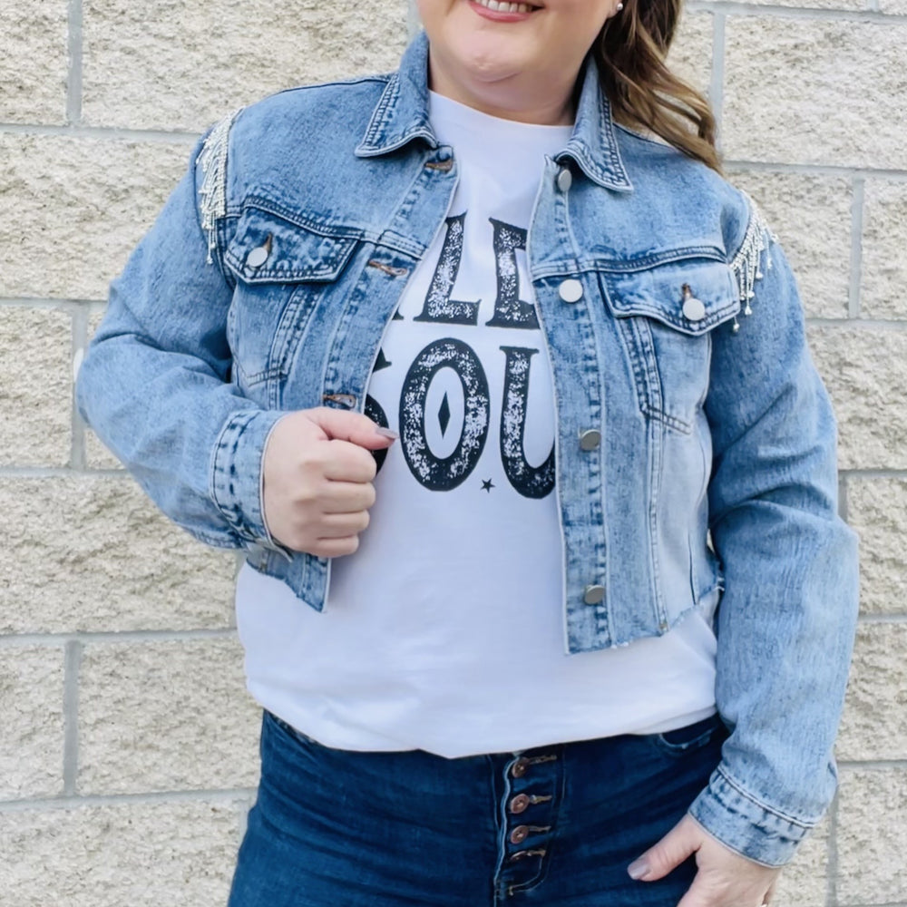 
                  
                    Elevate your style with this edgy denim jacket. With rhinestone details on the sleeves, this jacket will turn heads wherever you go. The distressed hemline gives it a unique edge that you'll love. Perfect for a night out or for everyday wear, this jacket is a must-have in your wardrobe.  Details Rhinestones details on sleeves Cropped Distress hemline 87% Cotton | 8% Poly | 5% Viscose
                  
                
