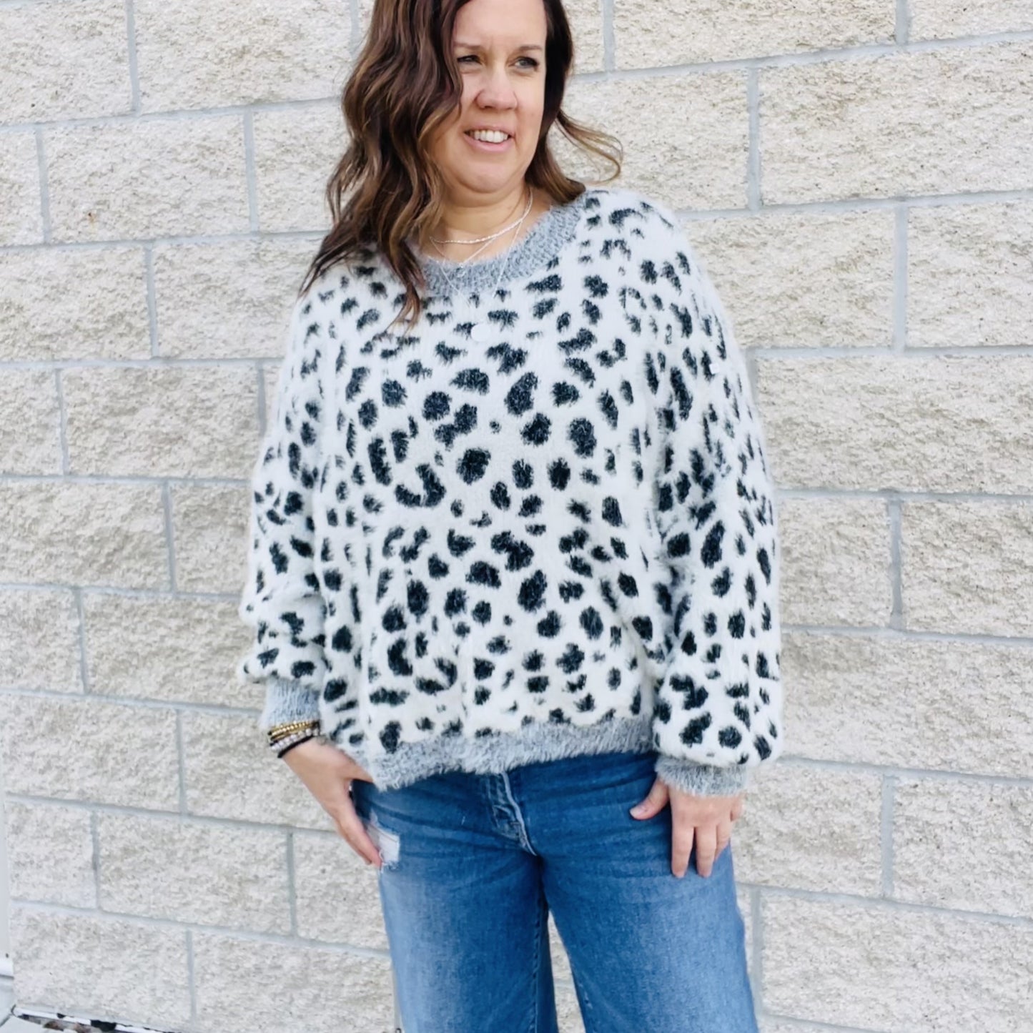 Add a bit of wildness to your style. This black and white leopard print sweater is the perfect way to add a touch of fun to your wardrobe. With its wide sleeves and soft, cozy fabric, it's perfect for chilly days. Match it with your favorite jeans or dress it up with a skirt. No matter how you wear it, you'll love the leopard print sweater.  Details Leopard Love Relax Fit Wide Sleeves Comfy and Cozy Color Black and white with gray trim