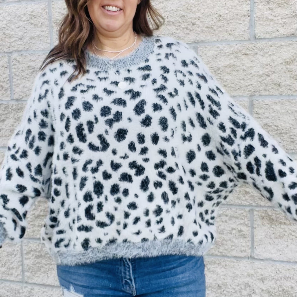 
                  
                    Add a bit of wildness to your style. This black and white leopard print sweater is the perfect way to add a touch of fun to your wardrobe. With its wide sleeves and soft, cozy fabric, it's perfect for chilly days. Match it with your favorite jeans or dress it up with a skirt. No matter how you wear it, you'll love the leopard print sweater.  Details Leopard Love Relax Fit Wide Sleeves Comfy and Cozy Color Black and white with gray trim
                  
                