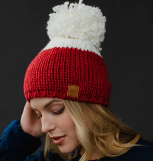 Color block knit hat with large pom accent