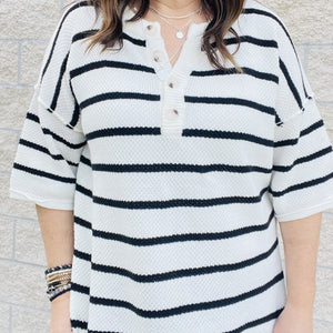 You'll love the way you look in this striped knit top! With an easy transitional sweater design, this top is perfect for those in-between seasons. Dolman sleeves and a loose fit make it a top you'll love to wear all day long. Whether you're dressing it up or keeping it casual, this top is a must-have in your wardrobe.  Details Dolman Sleeves Loose Fit Black and White 60% Cotton 40% Acrylic