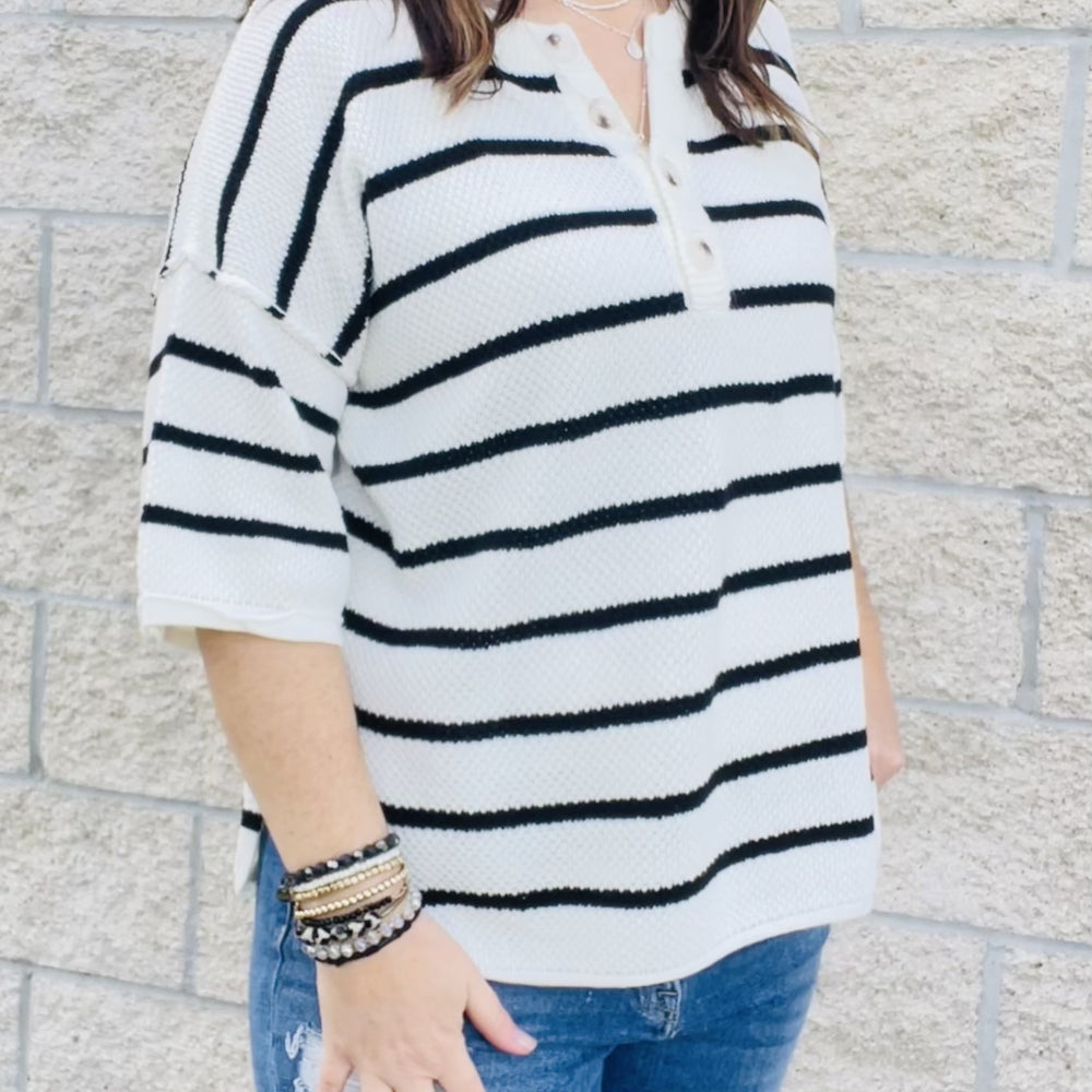 
                  
                    You'll love the way you look in this striped knit top! With an easy transitional sweater design, this top is perfect for those in-between seasons. Dolman sleeves and a loose fit make it a top you'll love to wear all day long. Whether you're dressing it up or keeping it casual, this top is a must-have in your wardrobe.  Details Dolman Sleeves Loose Fit Black and White 60% Cotton 40% Acrylic
                  
                