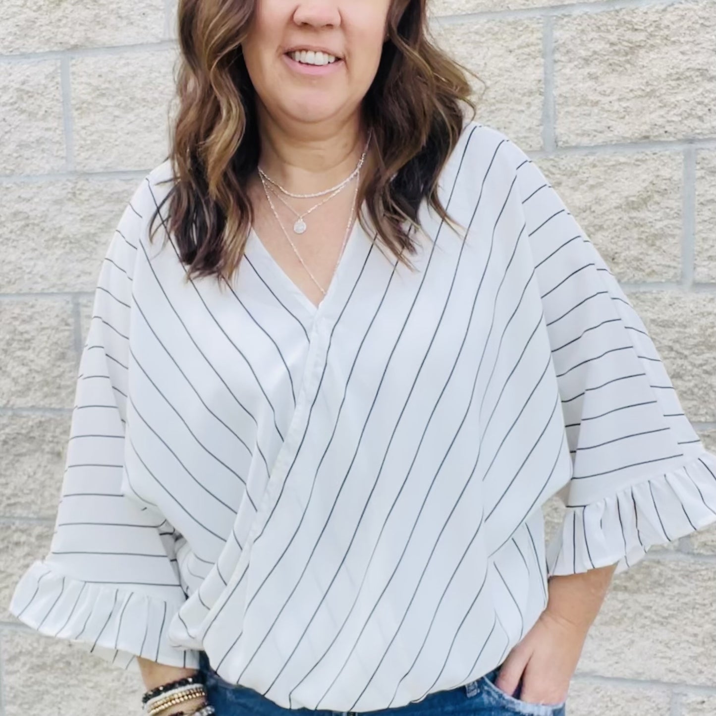 Casual surplice top with striped pattern throughout. Bell sleeves, elastic on front with easy fit. Woven, non sheer  100% Poly