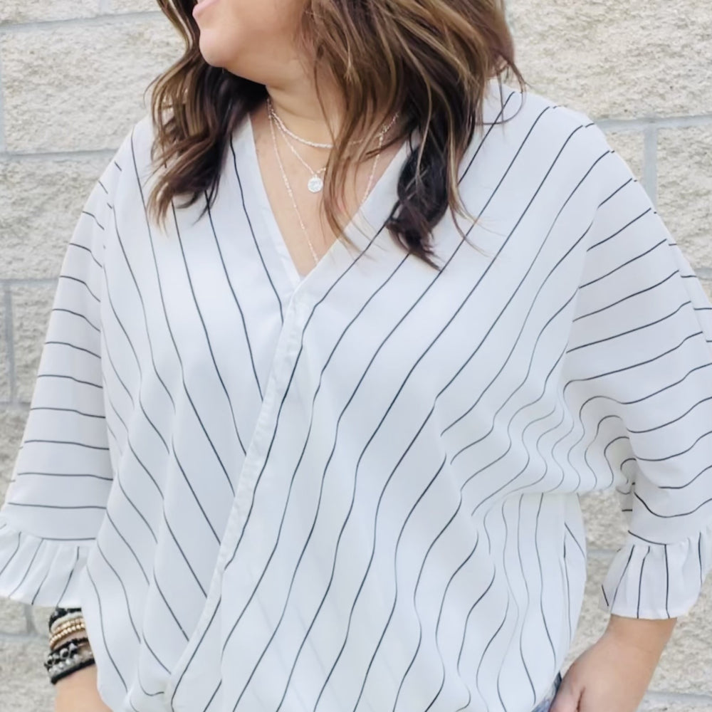 Casual surplice top with striped pattern throughout. Bell sleeves, elastic on front with easy fit. Woven, non sheer  100% Poly