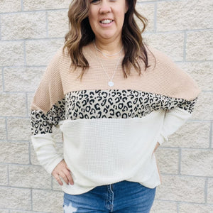 Be a trendsetter this winter in our Waffle Color Block Leopard Top. With a trendy leopard print and a comfortable waffle fabric, this top is perfect for a winter day out. With long sleeves and a stylish color block, this top will keep you warm and looking chic. Pair this top with jeans and a cardigan for a winter day look that will keep you comfortable and stylish.  Details Waffle Fabric Leopard Print Color Block Loose Fit Long Sleeves