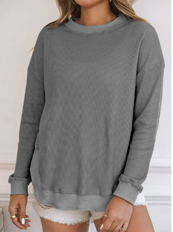 A comfy and chic top for any day of the week. Chic and trendy, this ribbed crew neck top is perfect for giving your everyday look a boost. The soft pink or cool gray color is perfect for adding a feminine touch, and the waffle fabric makes it super soft and cozy. Whether you're running errands or meeting up with friends, this top is the perfect companion. Add it to your wardrobe and wear it with everything from jeans to skirts.