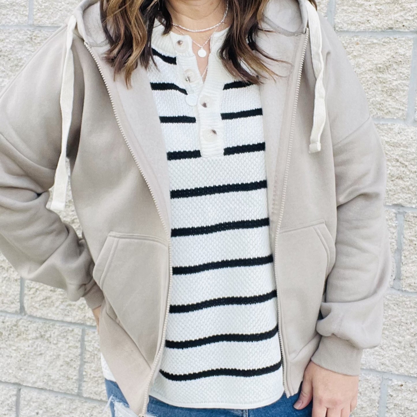 You'll love the way you look in this striped knit top! With an easy transitional sweater design, this top is perfect for those in-between seasons. Dolman sleeves and a loose fit make it a top you'll love to wear all day long. Whether you're dressing it up or keeping it casual, this top is a must-have in your wardrobe.  Details Dolman Sleeves Loose Fit Black and White 60% Cotton 40% Acrylic